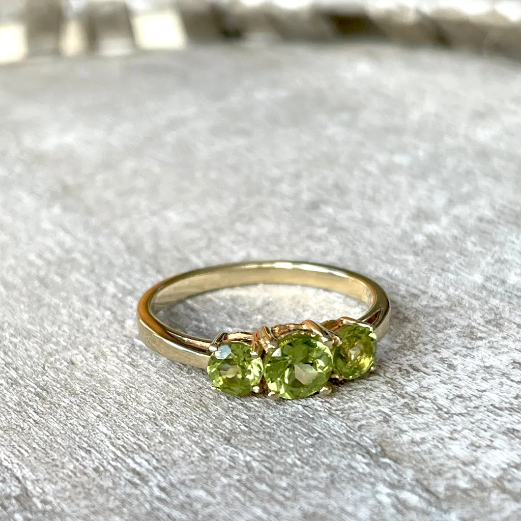 Elegant Trilogy Round Cut Peridot Yellow Gold Ring