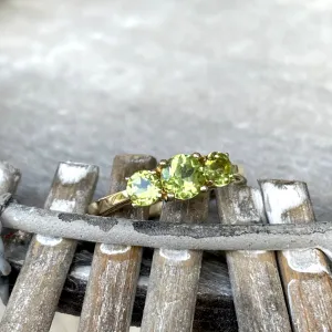 Elegant Trilogy Round Cut Peridot Yellow Gold Ring